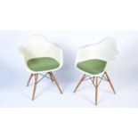 Vitra after a design by Charles and Ray Eames: a pair of white plastic chairs.