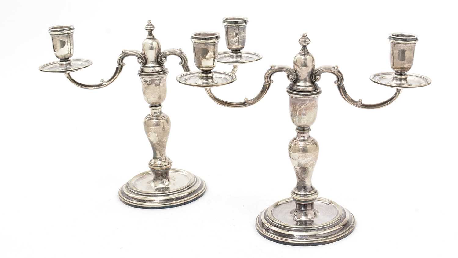 A pair of Elizabeth II silver twin light candelabra.