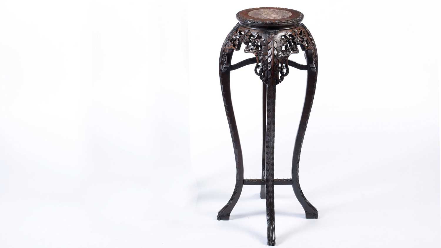 A Chinese carved hardwood circular jardiniere stand.