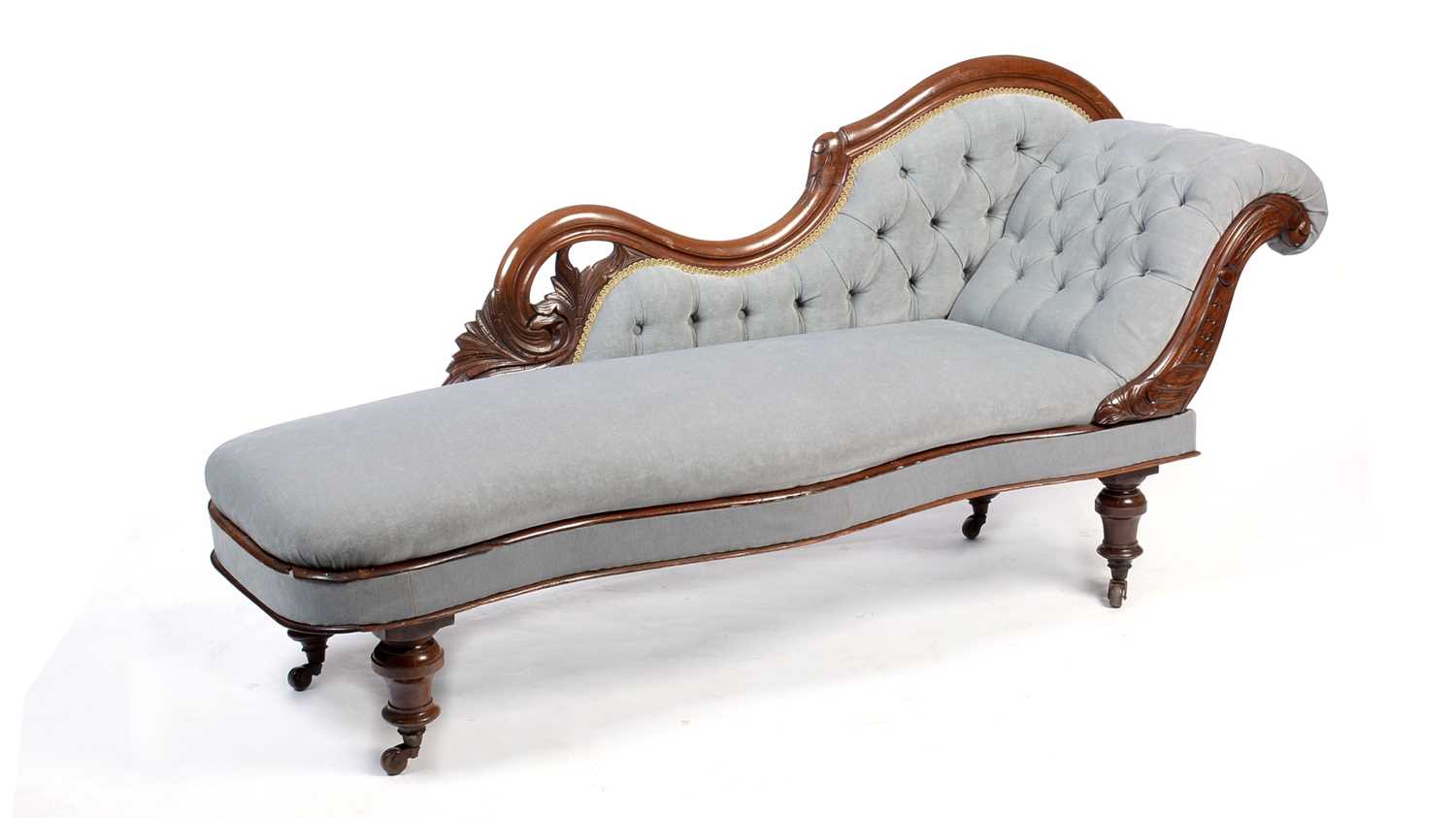 A Victorian carved walnut and button-upholstered chaise longue.