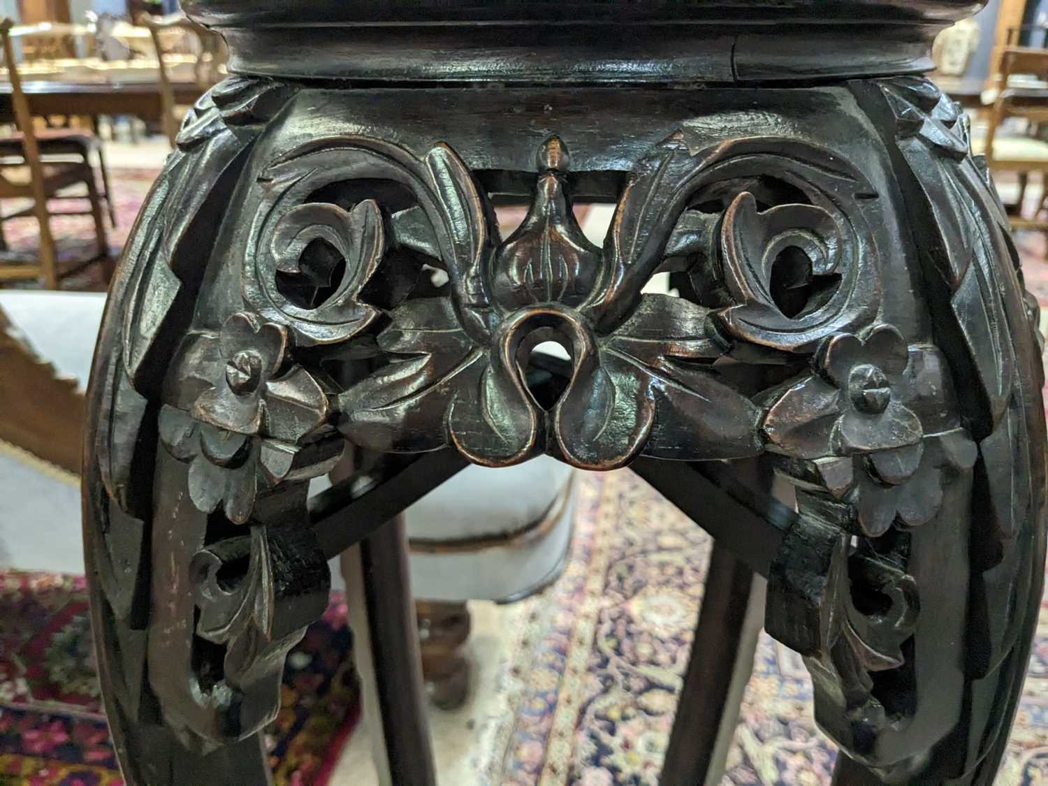 A Chinese carved hardwood circular jardiniere stand. - Image 12 of 17