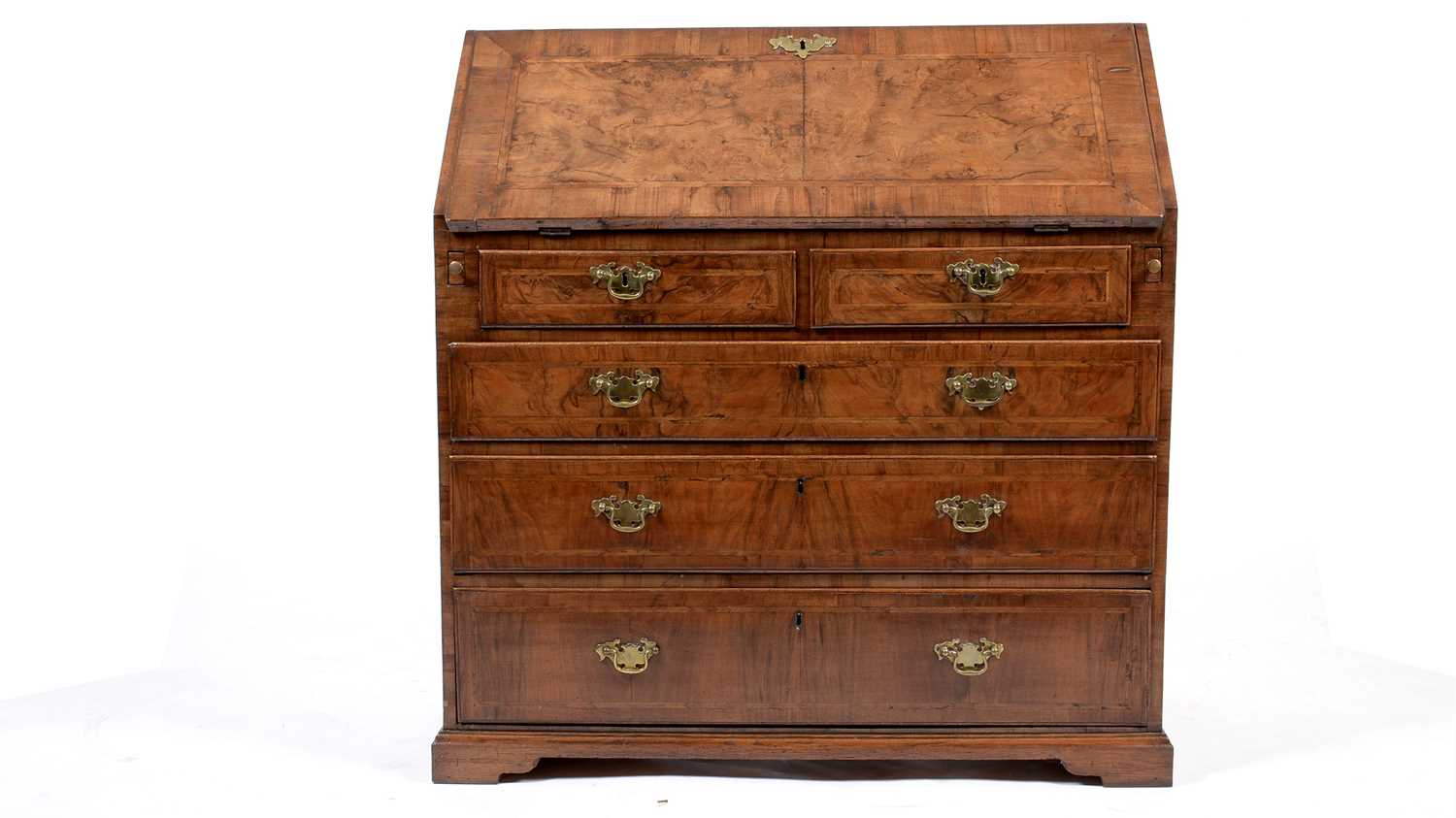 An early Georgian burr walnut and feather banded bureau