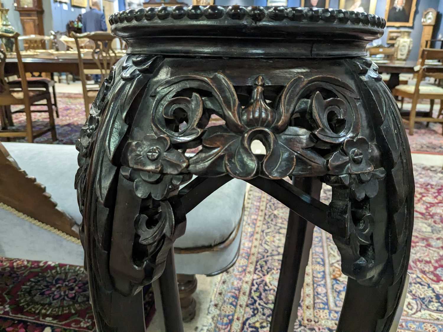 A Chinese carved hardwood circular jardiniere stand. - Image 10 of 17