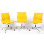 A set of three contemporary Eames EA 105 style office chairs by Vitra
