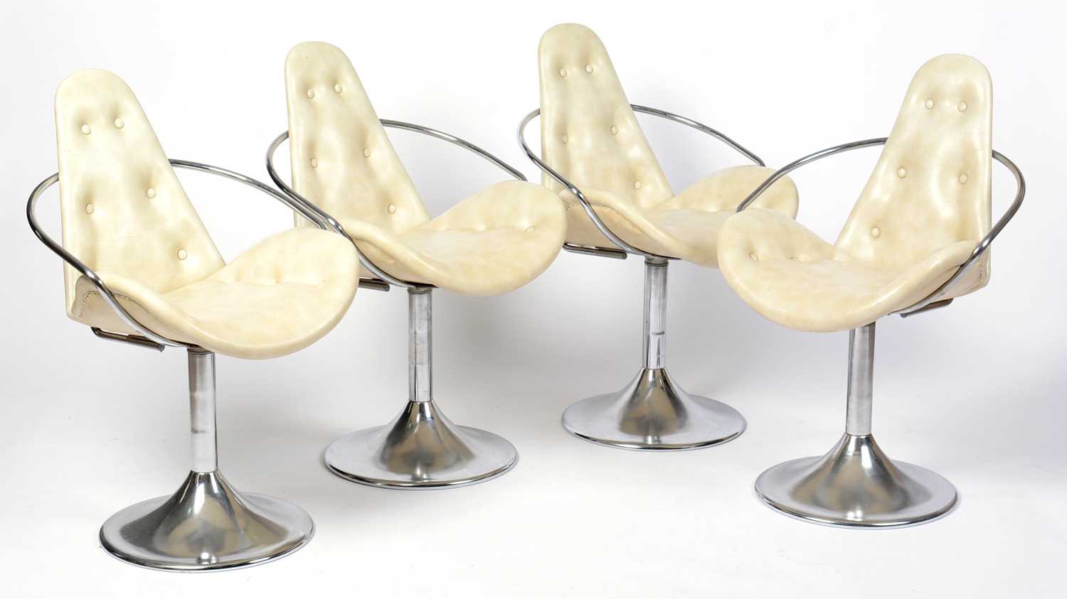 A set of four stylish retro vintage mid 20th Century cocktail chairs upholstered in cream leather