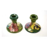 Pair of Moorcroft Hibiscus pattern dwarf candlesticks