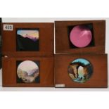 A collection of 23 early 20th Century mahogany framed Magic Lantern slides