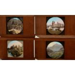 A collection of 60 early 20th Century mahogany framed coloured Magic Lantern slides