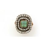 An emerald and diamond cluster ring,