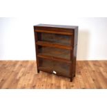 A 20th Century oak framed three section graduated stacking Globe Wernicke style glazed bookcase