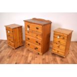 A 20th Century pine chest of drawers with a pair of pine bedsides