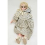 An early 20th Century bisque headed doll
