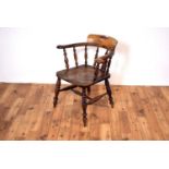 A 19th century Victorian Windsor smokers bow-back beech and elm armchair,