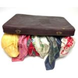 A selection of silk and other scarves and neckties, contained in a vintage Antler travel suitcase