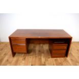 A large modern stained hardwood office desk