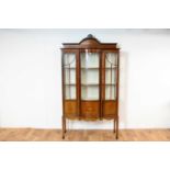 An Edwardian mahogany concave inlaid china display cabinet