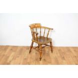 A Victorian beech and elm smokers bow/Captains chair