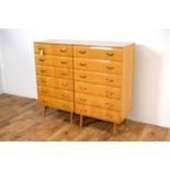 A pair of retro vintage hardwood chests of drawers of upright form