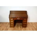 A large early 20th Century oak roll-top desk