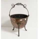 An Arts & Crafts copper and cast iron coal scuttle