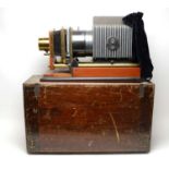 An early 20th Century brass, ebonised metal and mahogany Magic Lantern