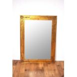 A reproduction gilt wall mirror of rectangular form