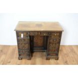 An oak Jacobean Revival kneehole desk of small proportions