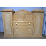 A large stripped pine compactum/wardrobe