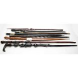 A collection of African walking sticks and spears