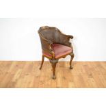 A decorative early 20th Century mahogany bergère chair