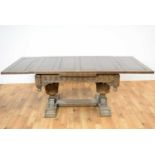 An impressive mid 20th Century Jacobean revival carved oak extending dining table