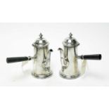 A pair of silver plated chocolate pots