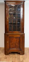 A 20th Century glazed mahogany corner cabinet