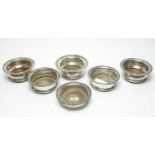 A selection of silver plated wine slides or coasters