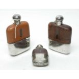 A collection of three antique hip flasks