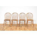 A set of four beech and elm spindle-backed dining chairs
