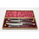 A cased horn handled carving set