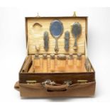 An early 20th Century brass bound leather vanity case