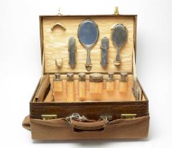 An early 20th Century brass bound leather vanity case