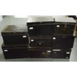 A collection of vintage black lacquered tin boxes