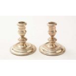 A pair of silver candlesticks, by Harrods Ltd