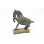 A Chinese bronze horse, on a stained wood rectangular base