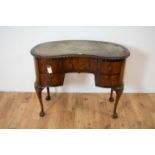 A Queen Anne style mahogany kidney shaped desk