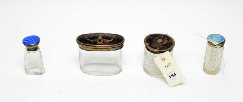 Four early 20th Century dressing table jars with silver covers