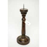 A 17th Century stained oak pricket candlestick