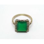 A green glass and diamond cluster dress ring