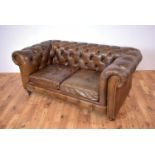 A modern brown leather Chesterfield sofa