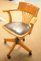 An early 20th Century oak captain's swivel chair