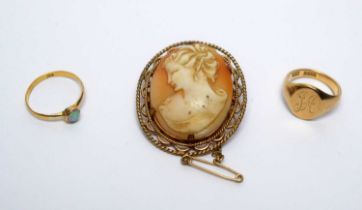 An opal ring; signet ring; and a cameo brooch