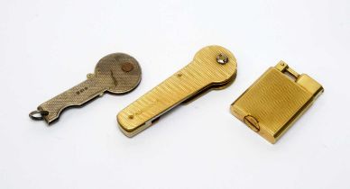 A 9ct gold lighter; 9ct gold key mount; and a silver key mount